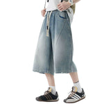 Pantalones vaqueros desgastados de pierna ancha y corte cropped