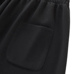 Pantalones deportivos holgados de color gris oscuro