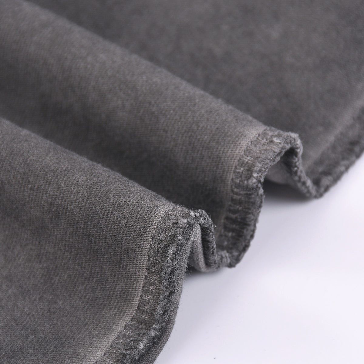 Camiseta sin mangas con borde sin rematar y costura trasera de 7.5 oz