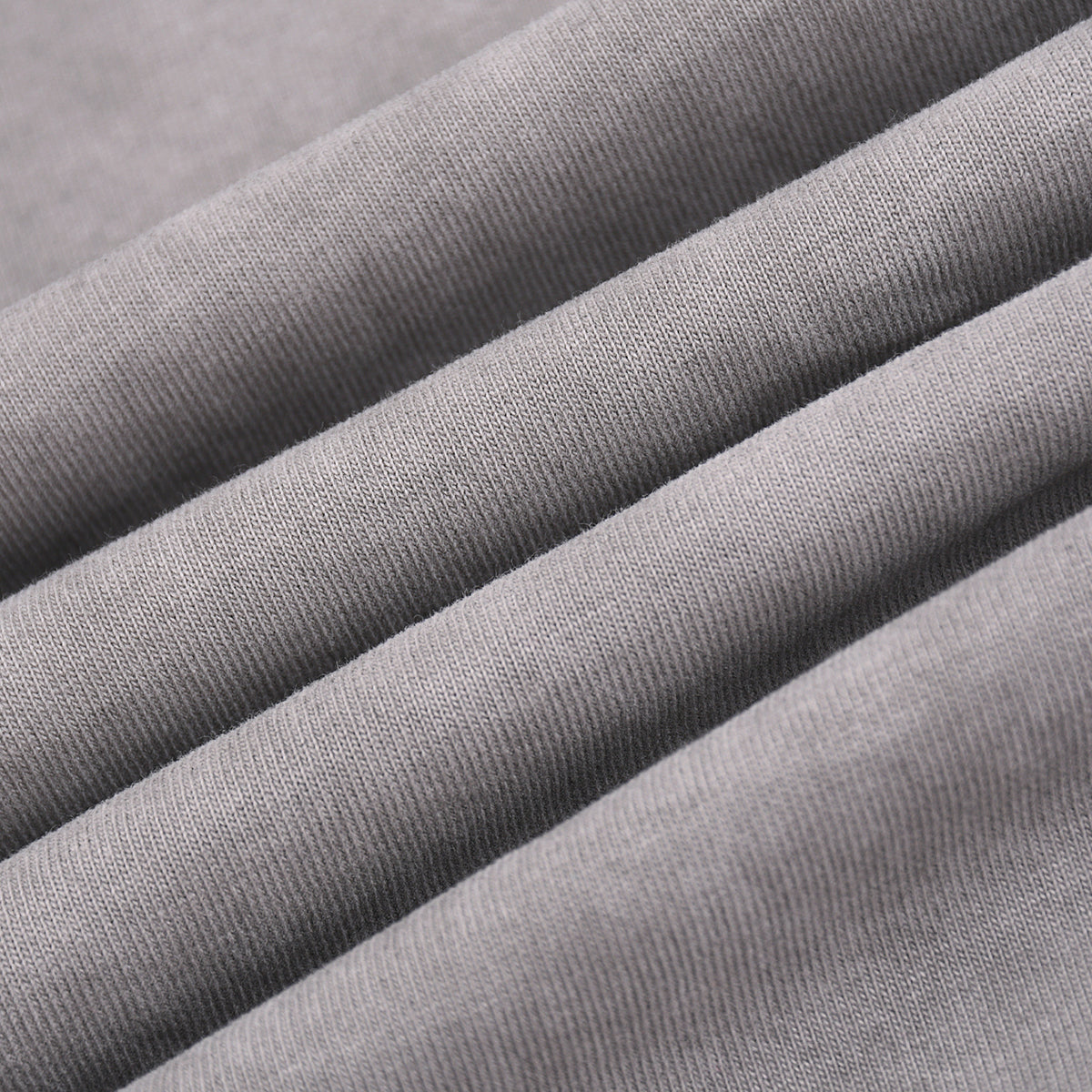 Camiseta sin mangas con borde sin rematar y costura trasera de 7.5 oz