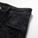 Vaqueros de cintura alta con aberturas y cuentas de perlas