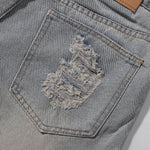 Bermudas vaqueras rasgadas con parches de camuflaje